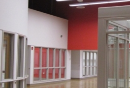 An interior view of the Glenarden Community Center, showing meeting rooms and a long hallway with red walls