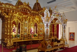 An interior view of the Shree Swaminarayan Temple Complex showing a gold altar